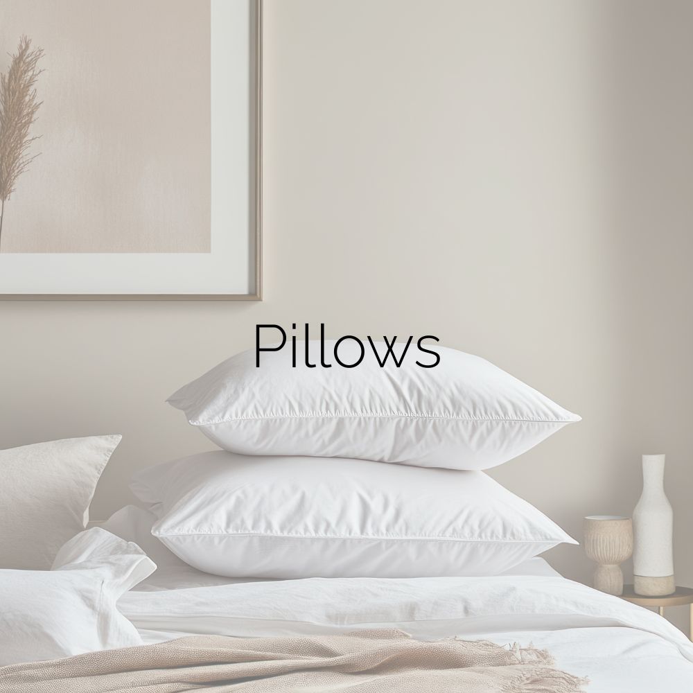 Several white pillows stacked on a bed. Image caption: “Pillows.”